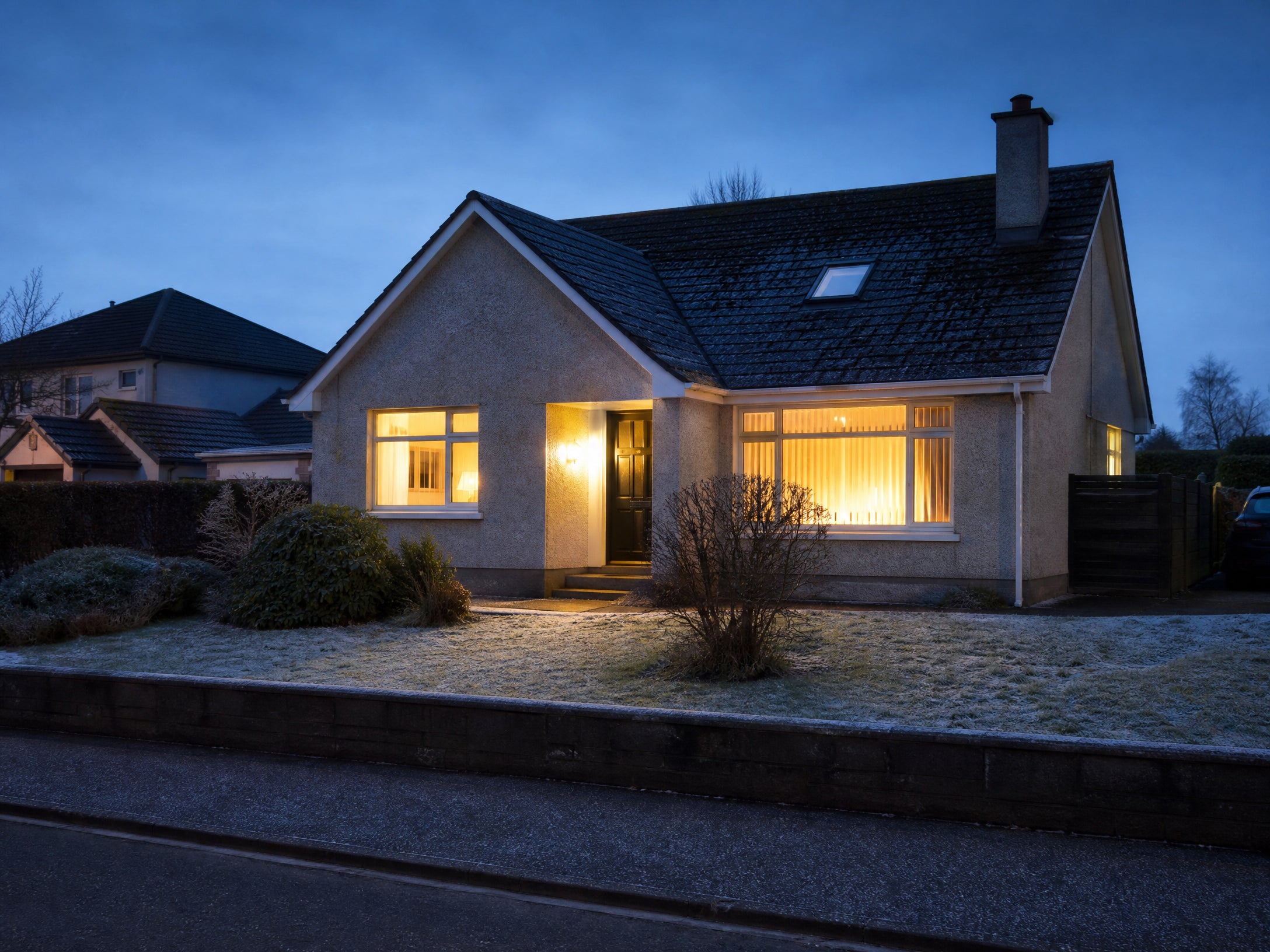 A normal family home on a cold evening with lights on